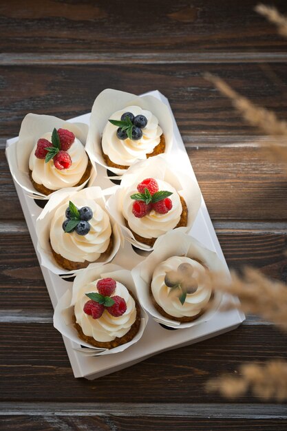 Cardboard stand with cream cakes and berries 3625