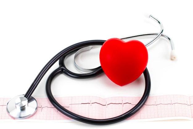 Cardiogram with stethoscope and red heart on white background, closeup.