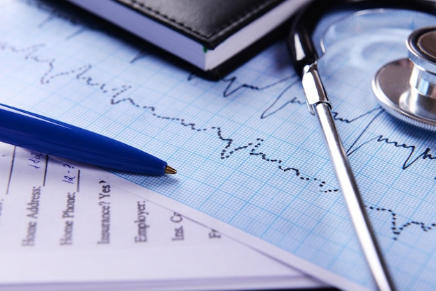 cardiogram with stethoscope on table closeup