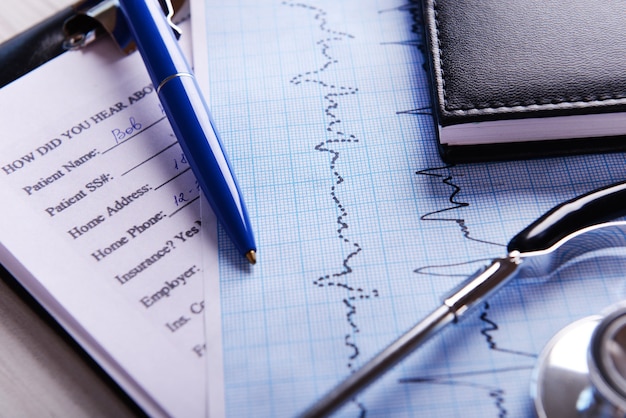 Photo cardiogram with stethoscope on table