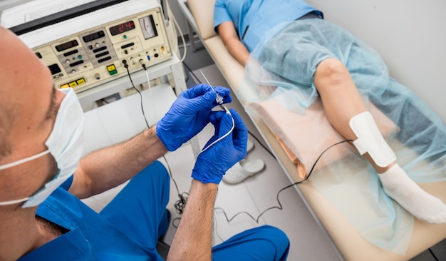 Photo cardiologist use tubes for radiofrequency catheter ablation.