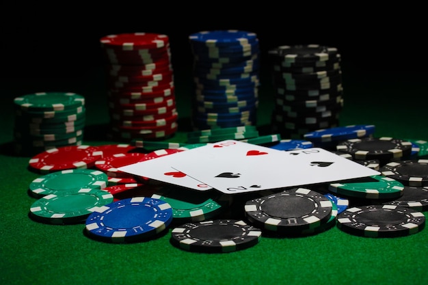 Cards and chips for poker on green table