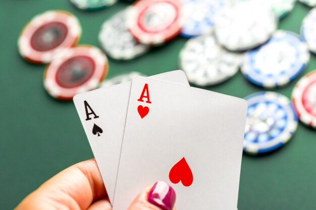 Cards and chips for poker on green table