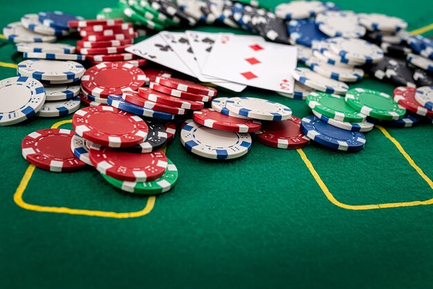 Cards and colored chips are scattered on the new green poker
table poker concept