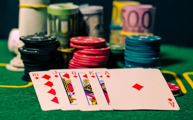 Cards with chips and money on the table in the casino.