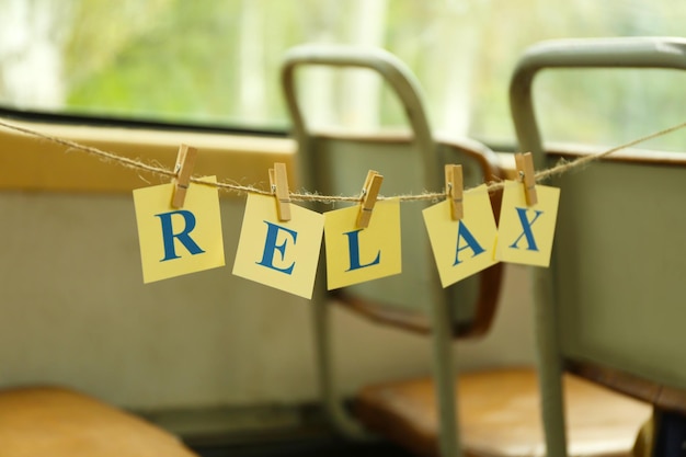 Cards with printed word RELAX on tram seats background