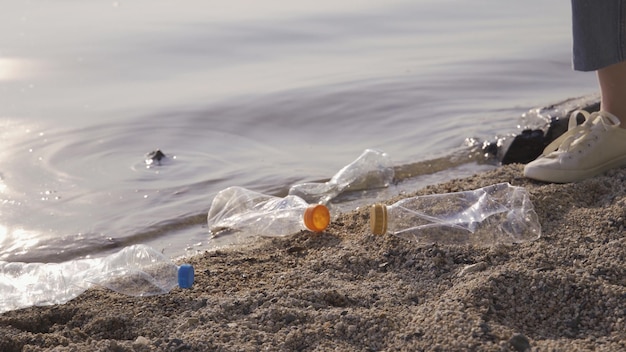 Care about nature. Volunteer girl collects trash in the trash bag. Trash-free planet concept. Nature cleaning, volunteer ecology green concept. Environment plastic pollution.