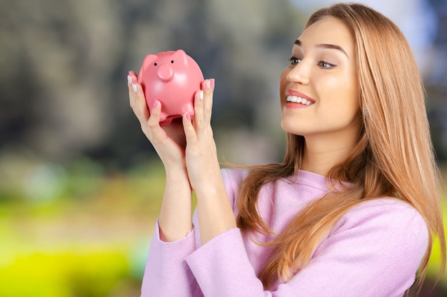 Care for Savings - Woman with a Piggy Bank