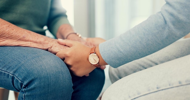 care senior or closeup of people holding hands for comfort or compassion for wellness together therapist sympathy or elderly person bonding praying or care after death with psychologist or heal