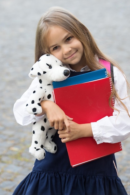 Photo care and trust. preschool child hug toy dog. back to school supplies. preschool education. afterschool care. daycare and nursery. kindergarten and playschool. intellectual growth. learn and develop.