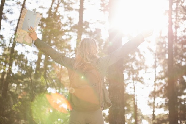 Carefree blonde hiker with arms outstretched 