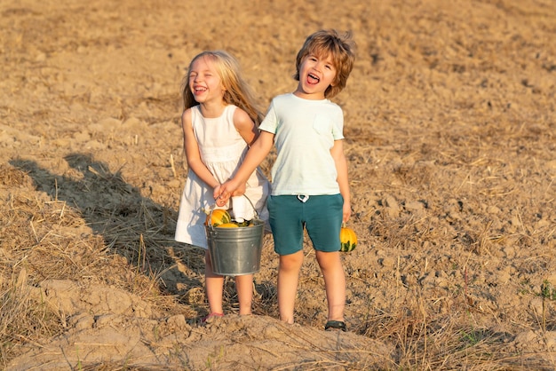 Carefree childhood. Two little children on countryside farm. Cute toddler girl and boy working on farm outdoors. Childhood concept. Children enjoy in farm. Eco farm workers.