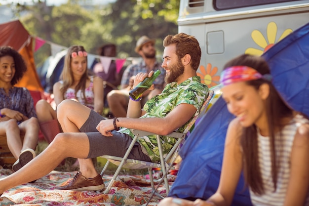 Carefree hipster relaxing on campsite