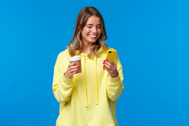 Carefree joyful european female in yellow hoodie