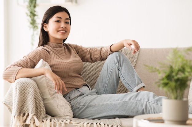 Carefree Teen Girl Looking at Camera Resting on Sofa