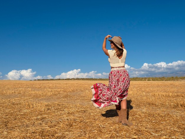 Carefree woman admiring dry field