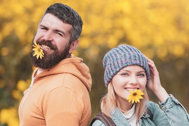 Carefree young woman with handsome bearded man in trendy vintage pullover