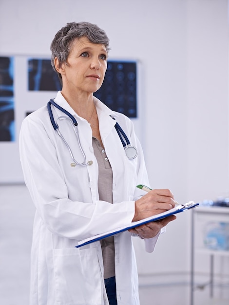 Careful observation in medicine Shot of a female doctor holding a clipboard