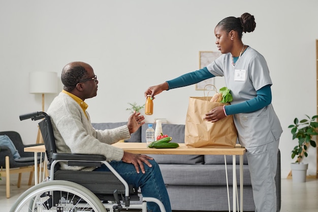 caregiver bringing healthy food for man