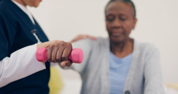 Photo caregiver elderly woman or dumbbell on bed to help exercise or wellness in physiotherapy nurse black person or fitness in bedroom in physical therapy senior patient or healthcare in retirement