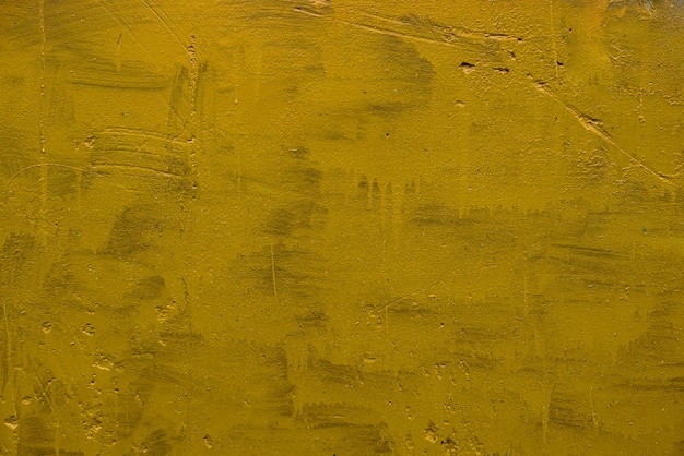 Photo carelessly painted yellow flat surface texture and full frame background