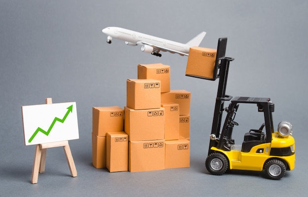 Cargo airplane, forklift truck with cardboard boxes and green arrow up