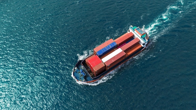 Cargo boat express boat carrying container and running for export goods from cargo yard port to custom ocean concept technology transportation customs clearance aerial top view freight