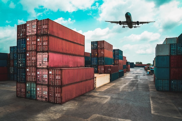 Photo cargo container for overseas shipping in shipyard with airplane in the sky .