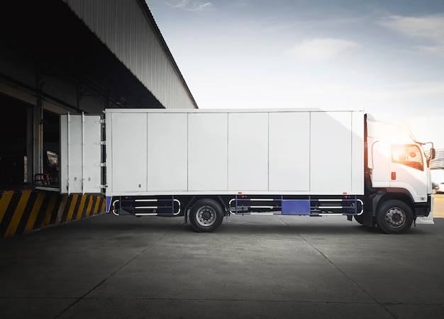 Cargo container trucks parked loading at dock warehouse
shipping cargo trucks distribution warehouse