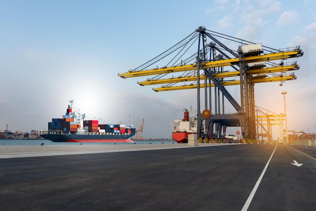 Cargo crane in the international yard port for loading big tank from ship to truck concept logistic shipping by sea