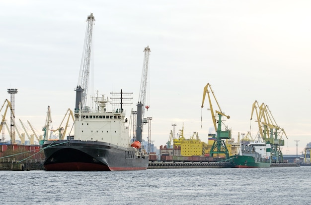 Cargo freight ship and cargo container working with crane at port area,Logistic Import Export.