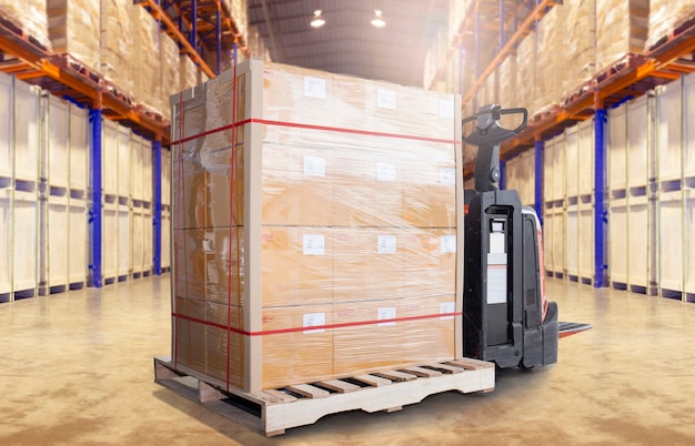 Cargo pallet shipment and electric forklift pallet jack in the warehouse storage.