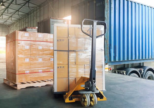 Cargo pallet shipment freight truck heavy cargo boxes with hand pallet truck waiting to load into container