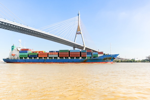 Cargo ship under the bridge