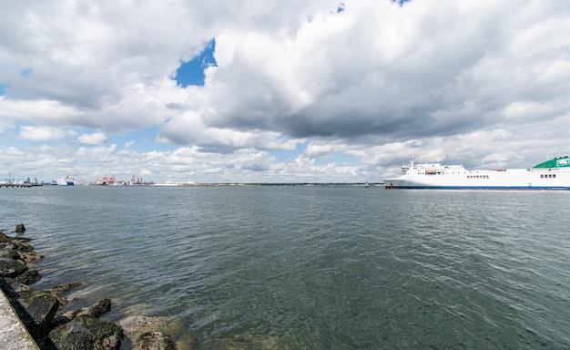 Cargo ship entering Dublin harbour at Poolbeg lighthouse from Irish see.