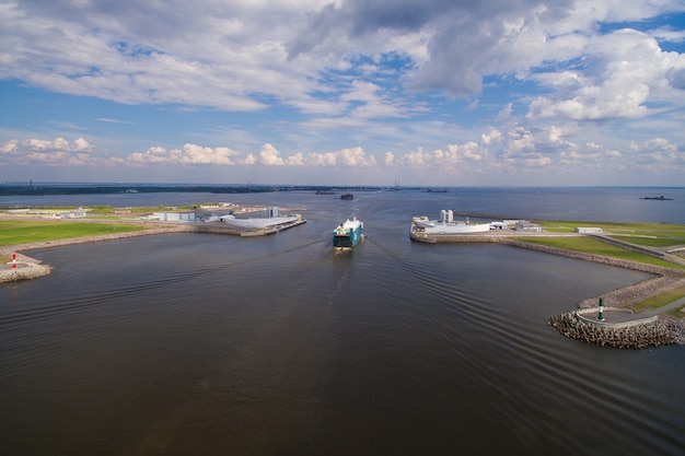 Cargo ship enters the shot of the dam