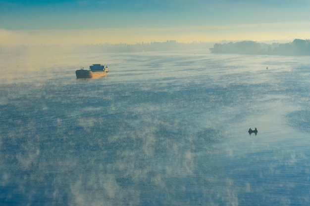 Cargo ship in fog on a river Dnieper