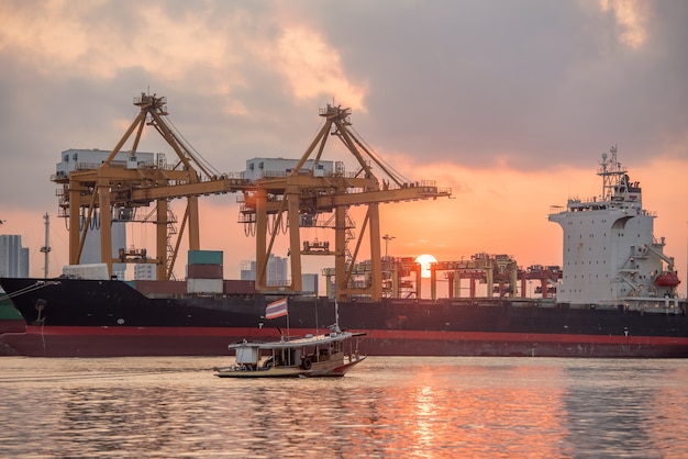 Cargo ship in the harbor at sunset