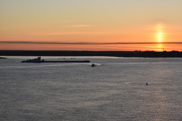 Cargo ship sails at dawn on the Volga