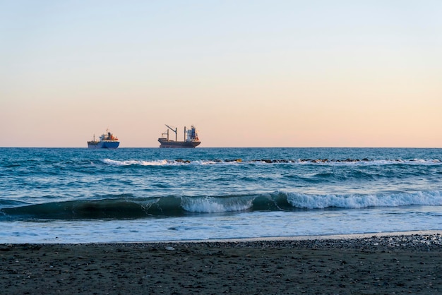 Cargo ships on the horizon of the Mediterranean sea