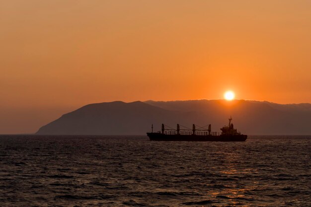 Cargo vessel at sea Bulk carrier Dry cargo ship at sunset Golden hour