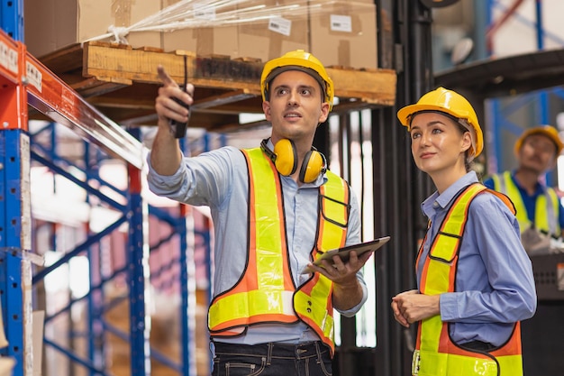Cargo warehouse professional working people caucasian male and woman talking together engineer teamwork