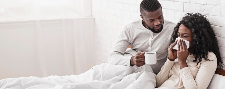 Photo caring african american husband bringing tea to his sick wife
