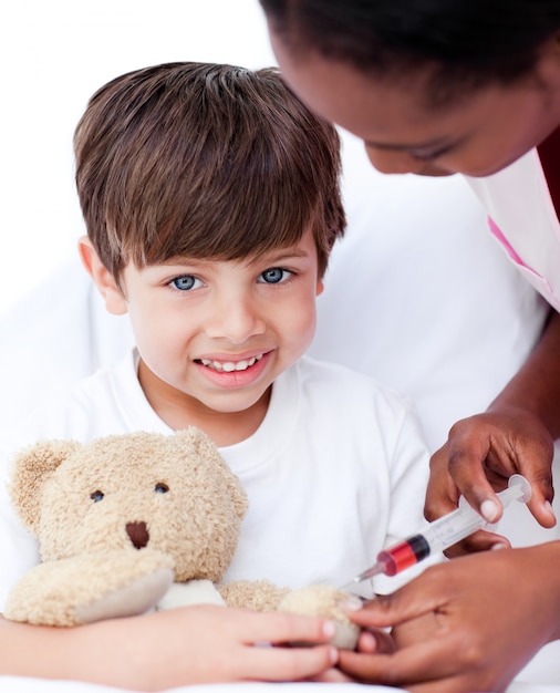 Caring female doctor playing with a little boy 