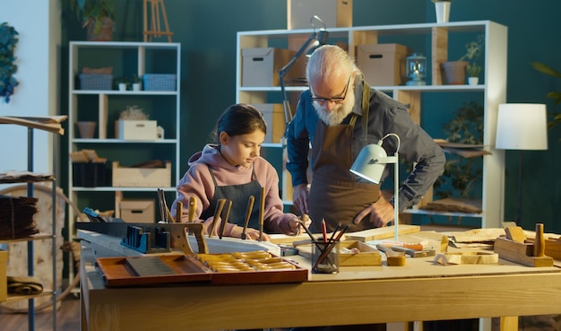 Caring Grandfather with his Teenage Granddaughter Spend Time Together Hobby