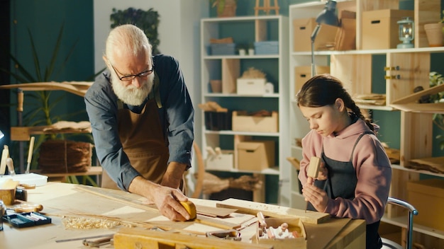 Caring Grandfather with his Teenage Granddaughter Spend Time Together Hobby