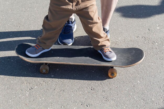 A caring and loving father teaches his threeyearold son to skateboard