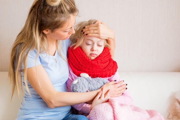 caring mother together with her sick child