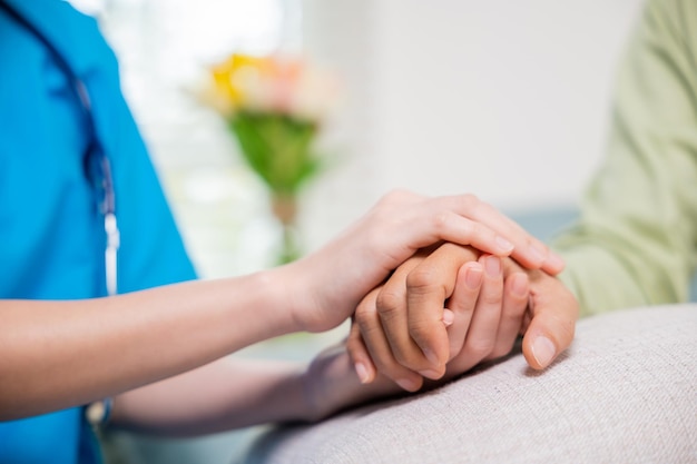 Photo caring nurse helping elderly old man care facility gets help