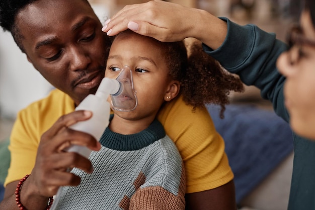 Photo caring parents with sick preschool daughter